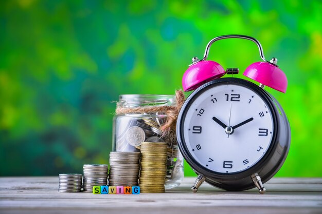 Alarm clock, Coins and cube dices with word Saving