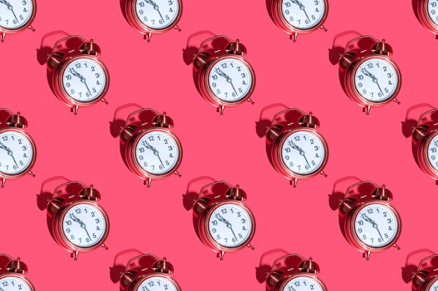 Alarm clock on a colored background hard shadows. Close up. Seamless patterns