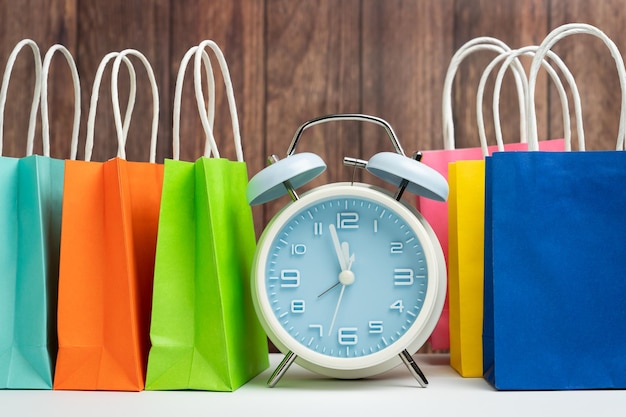 Alarm clock and colorful shopping bags