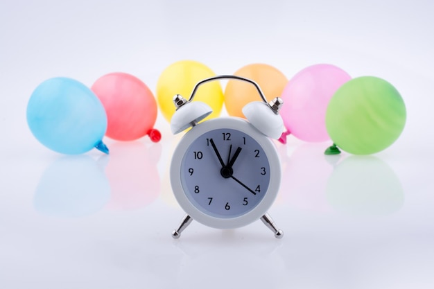 Alarm clock and colorful small Balloons