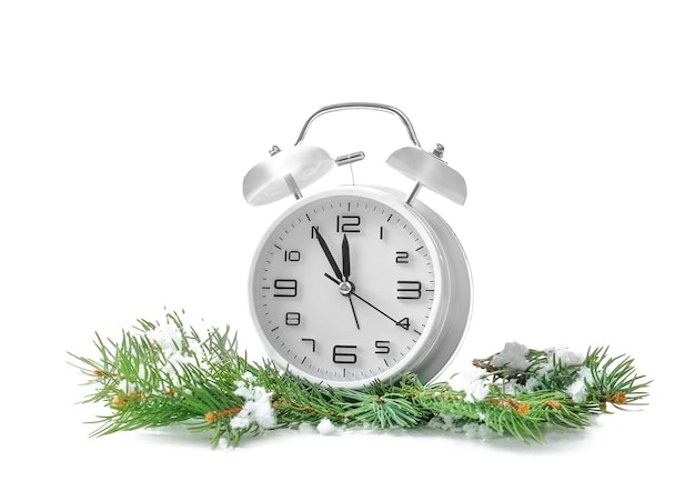 Alarm clock, fir branches and snow on white background. Christmas countdown concept