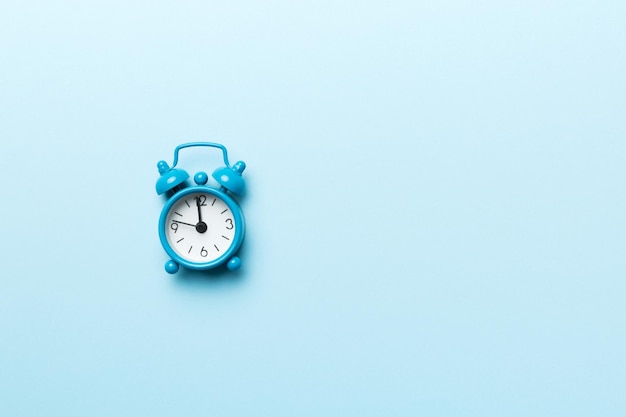 Alarm clock isolated on colored background with copy space top view