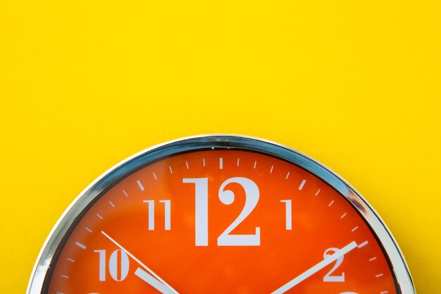 Alarm clock on isolated yellow background