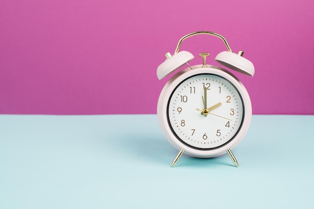 Alarm clock in old retro style, pastel color, time to wake up in the morning