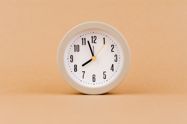 alarm clock photography in a light brown background studio the concept of time and living