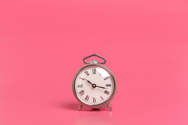 Alarm clock on pink 