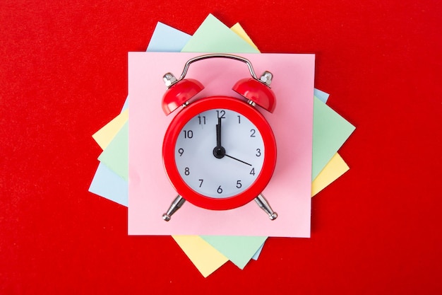 Alarm clock on red background