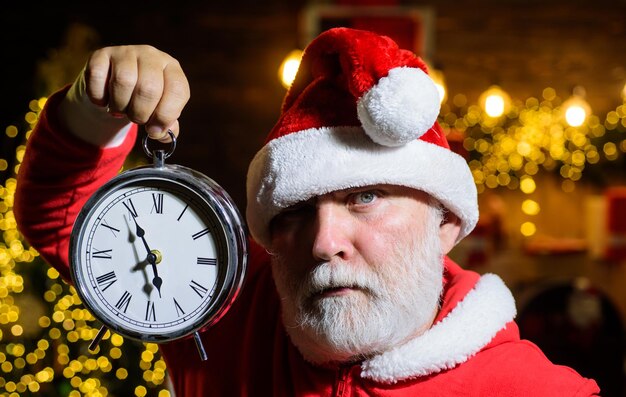 Alarm clock santa claus holds clock new year clock new year party santa celebrate christmas