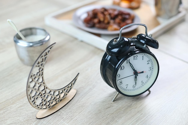 Photo alarm clock showing iftar ramadan time for breakfasting