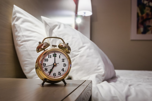 Alarm clock stands on a bedside table