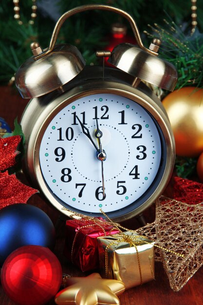 Alarm clock with Christmas tree and decorations close up