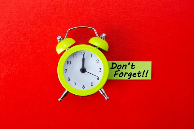 Photo alarm clock with don't forget word on red background