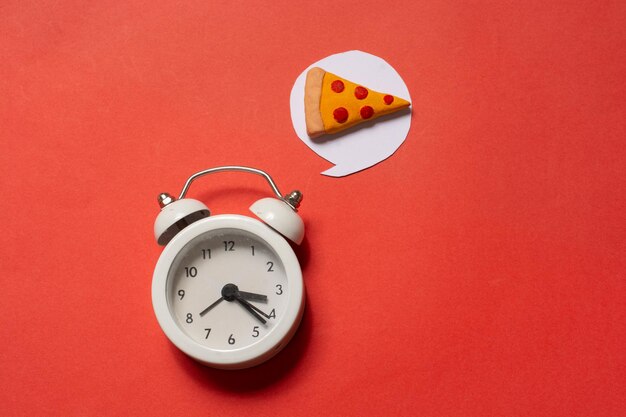 Alarm clock with a piece of pizza Pizza time Snack time