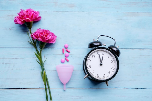 Alarm clock with roses pills and sanitary cup