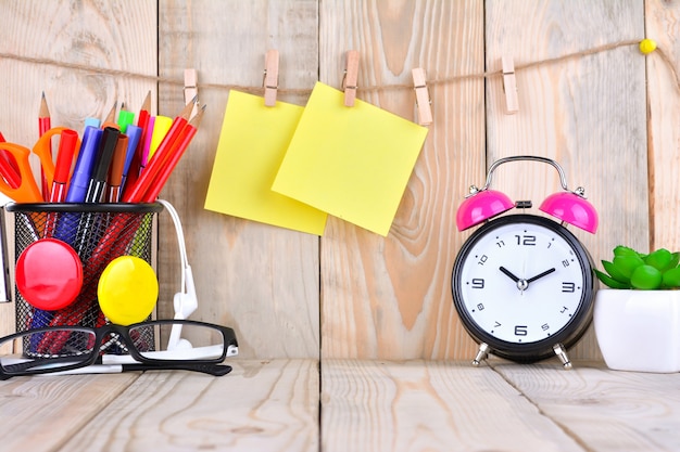 Photo alarm clock with sticky note on wooden table