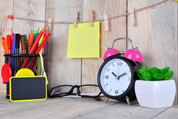 Photo alarm clock with sticky note on wooden table