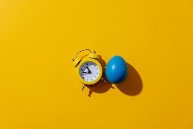 Alarm clock with two bells on yellow background