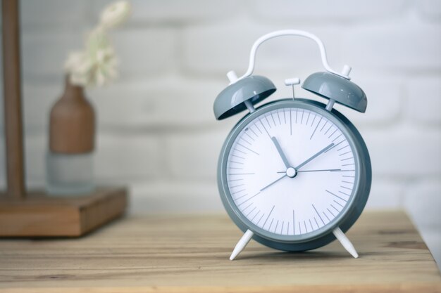 Alarm clock on wood table in the bedroom