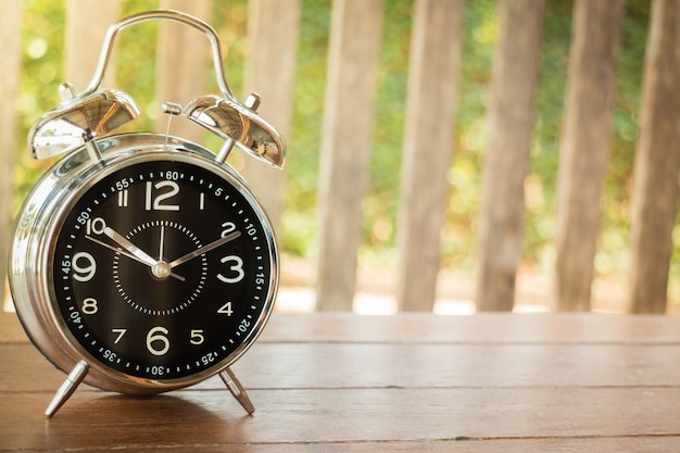 Alarm Clock On Wooden Background