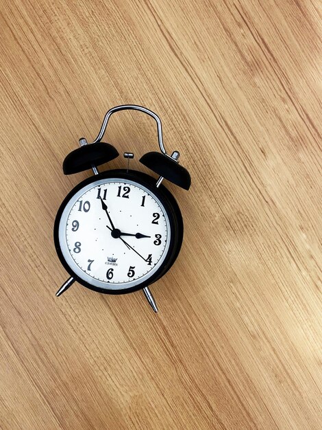 An alarm clock on a wooden surface