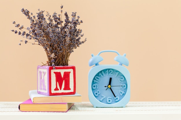 Alarm clock on wooden table close up