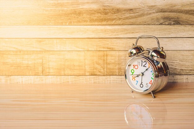 Photo alarm clock on wooden table