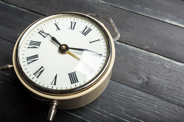 Alarm clock on a  wooden table