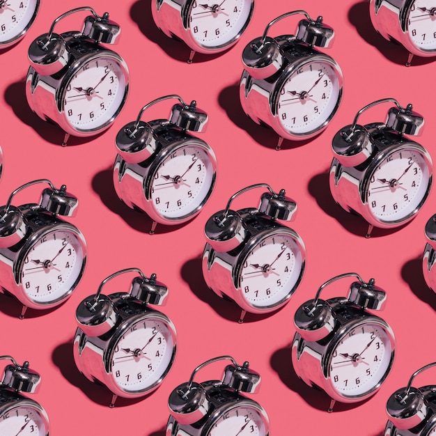 Alarm clocks on pink background