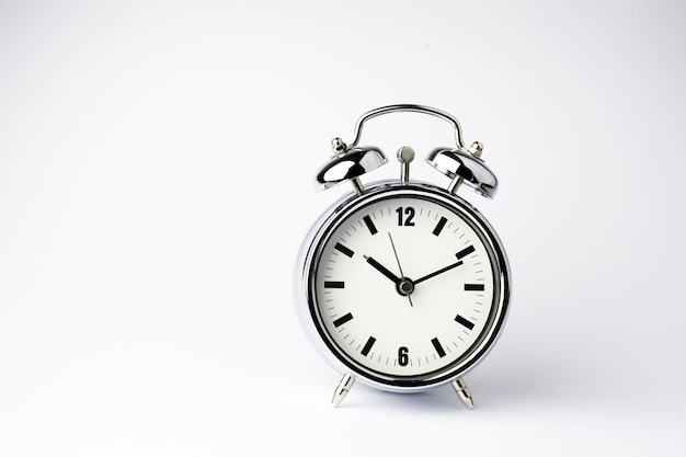 Alarm metal clock on white background