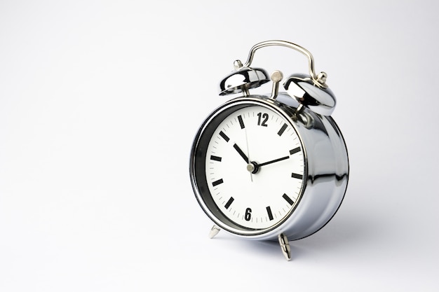 Photo alarm metal clock on white