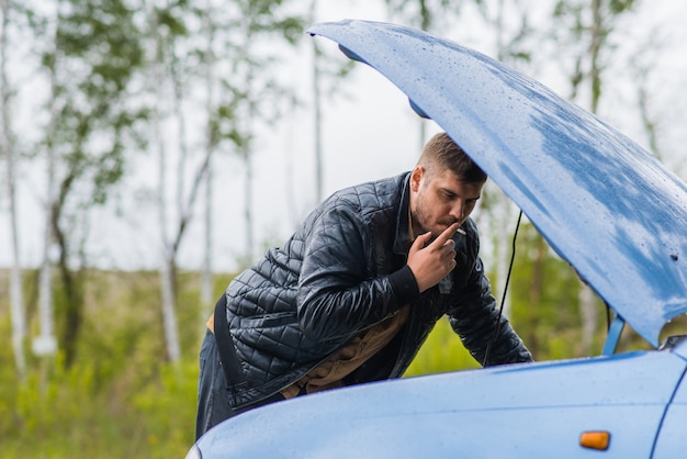 Alarmed driver tries to repair the car