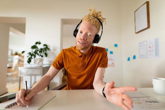 Photo albino african american man working from home making video call