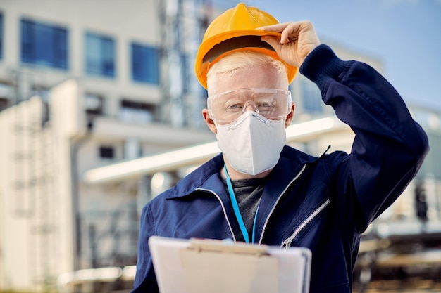 Albino construction engineer with protective workwear during coronavirus epidemic