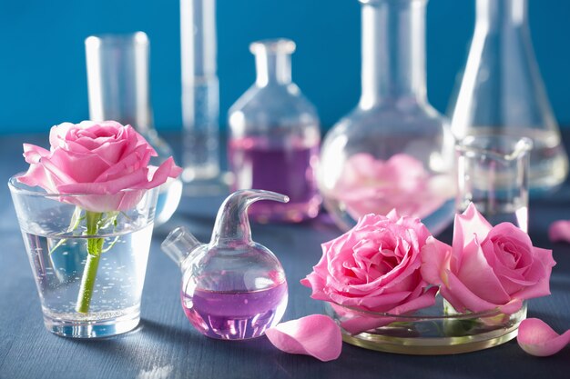 Alchemie en aromatherapie set met roze bloemen en chemische kolven