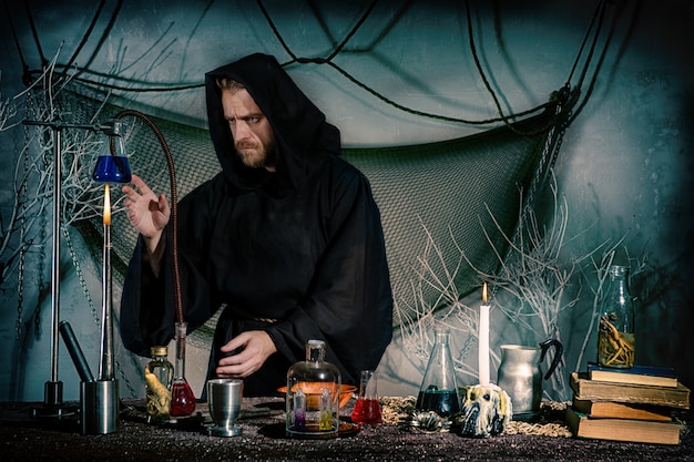 the alchemist works in the laboratory.