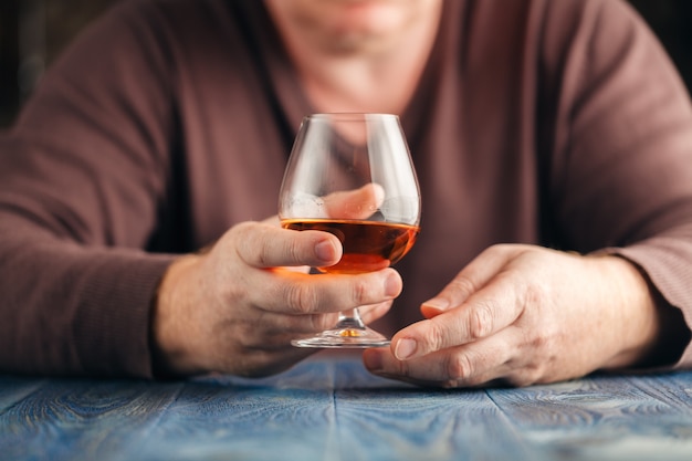 Alcohol abuse, alone man drink whisky for relax