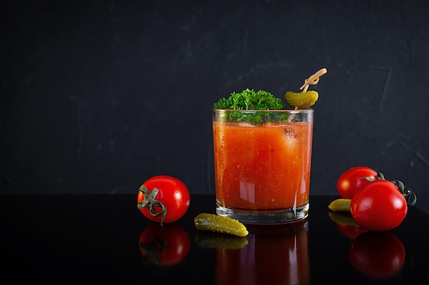 Alcohol cocktail Bloody Mary on dark background. Classic cocktail with tomato juice and vodka