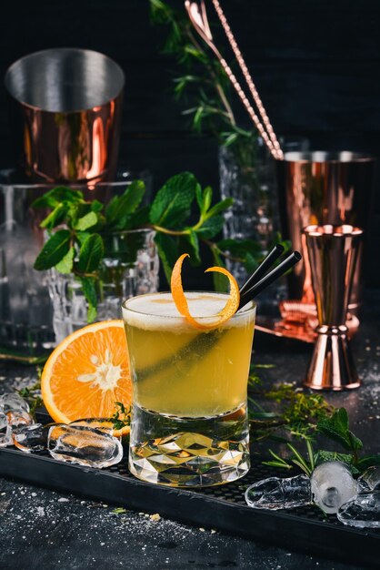 Alcohol Cocktail Whiskey Sauer On a black wooden background