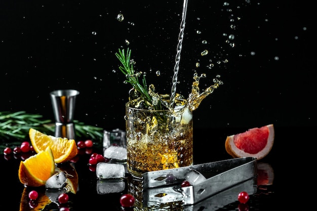 Alcohol cocktail with liquid splash freeze motion in jar glass on dark background