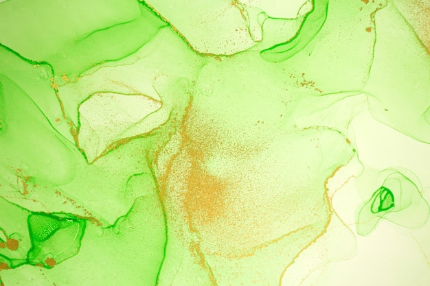 Alcohol ink gold and light green abstract background