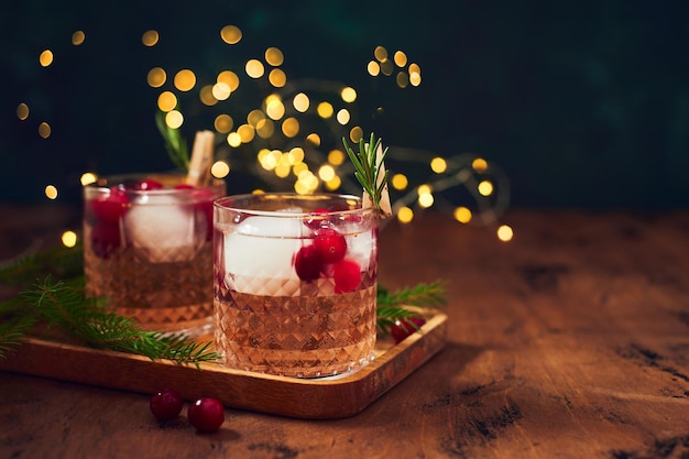 Alcoholic cocktail or nonalcoholic cocktail with vodka and cranberries with ice with fir branches an