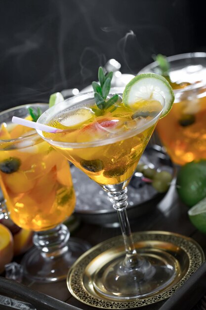 Alcoholic cocktail with fruit and ice