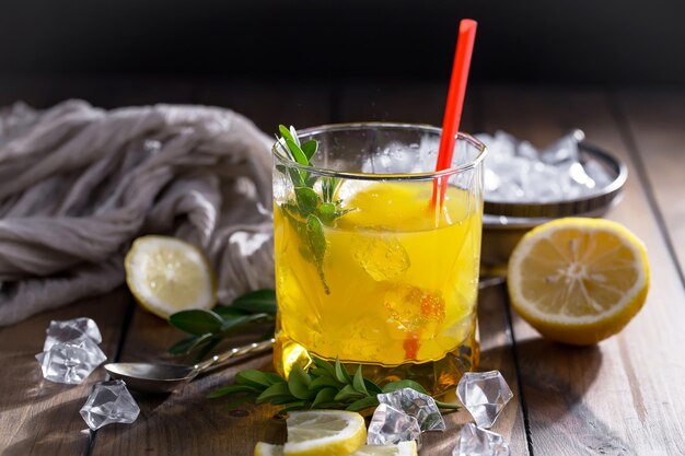 Alcoholic cocktail with fruit and ice