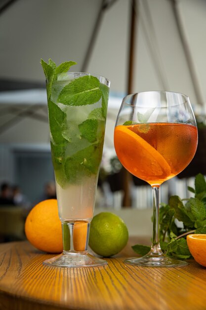 alcoholic cocktail with ice, orange, mint