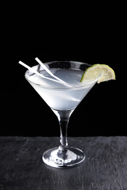 Alcoholic drinks at the bar. Bartender's hands in the process of making drinks.