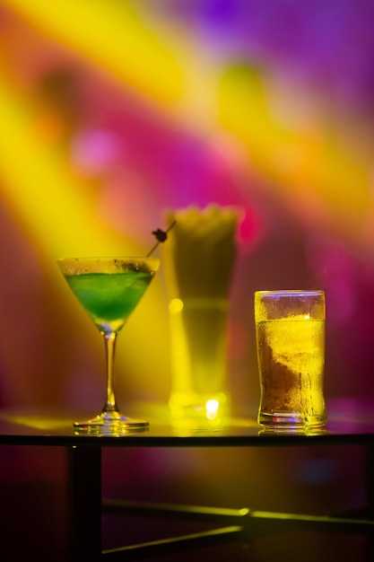 Alcoholic drinks served on glass table at party