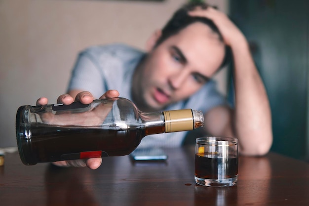 Alcoholic invokes a strong rum with a glass stack lying on the table Of strong alcoholic intoxication The concept of alcohol dependence Alcohol intoxication