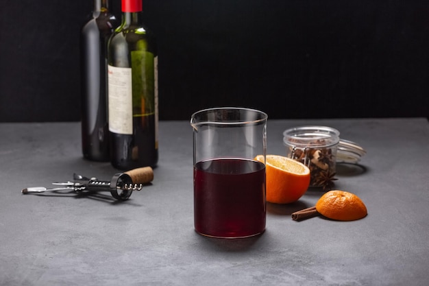 Alcoholic mulled wine with fruits and spices on a dark background, traditional alcoholic drink, Christmas