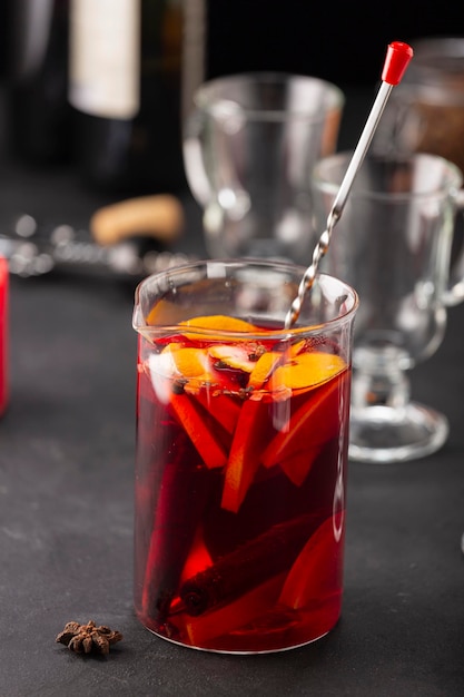 Alcoholic mulled wine with fruits and spices on a dark\
background traditional alcoholic drink christmas