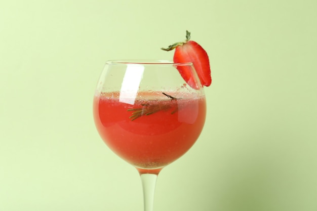 Alcoholic Rossini cocktail on light green background